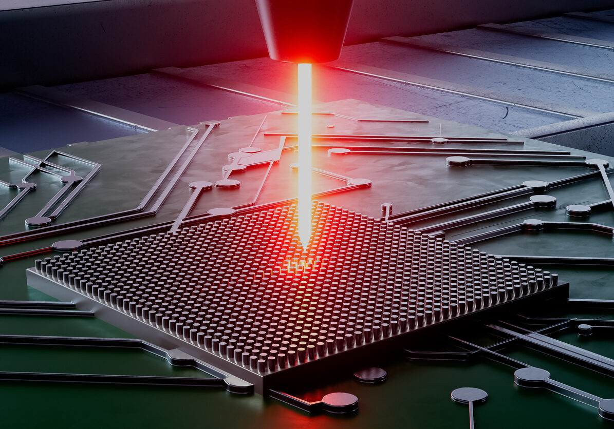 A computer chip is being laser cut. Concept of precision and technology. The laser beam is focused on the chip, highlighting the intricate details of the design